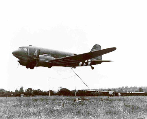 Glider at rest is being snatched airborne by C-47