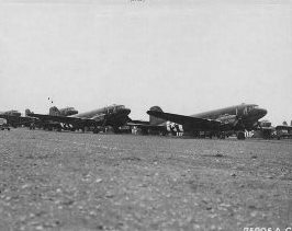 Tow planes and gliders of the 439th Troop Carrier Group are lines up on the
runway before the Hackensack mission