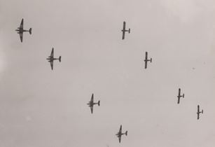 Douglas C-47 transports and the gliders in formation.