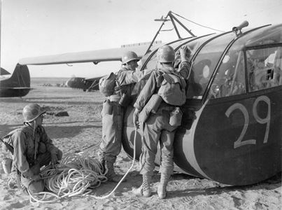 Artillermen hooking up tow rope to CG–4A glider.  African Air Force