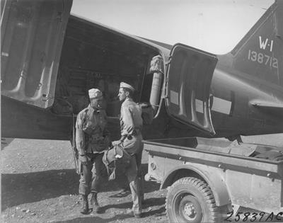 Artillermen hooking up tow rope to CG–4A glider.  African Air Force